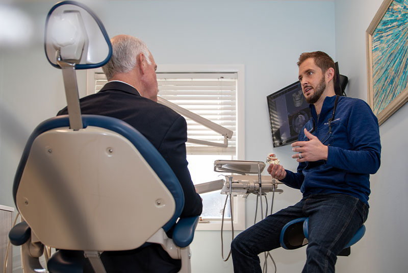 doctor going over dental treatment information with patient