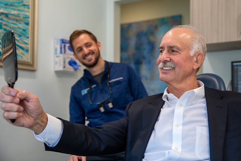 patient smiling brightly after their dental treatment within the dental center