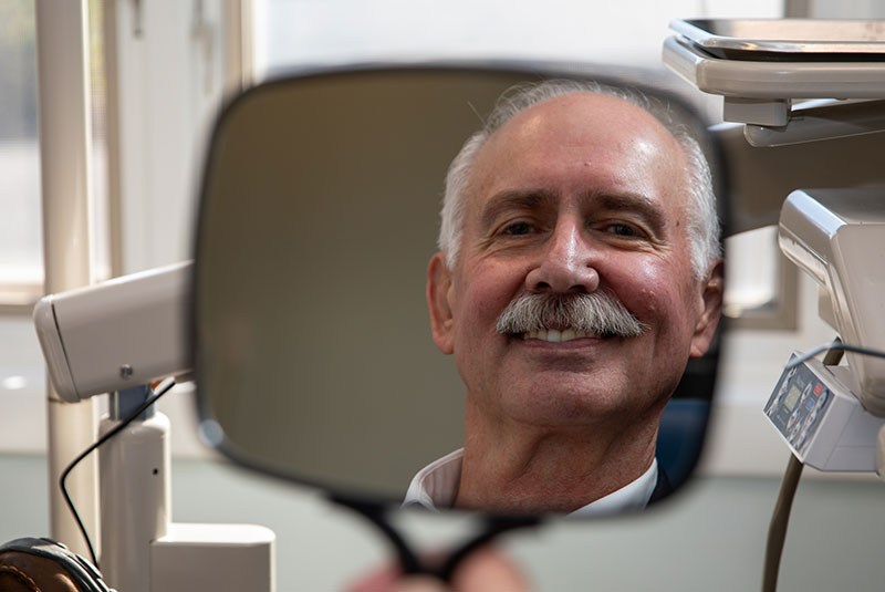 patient smiling brightly after their dental treatment within the dental center